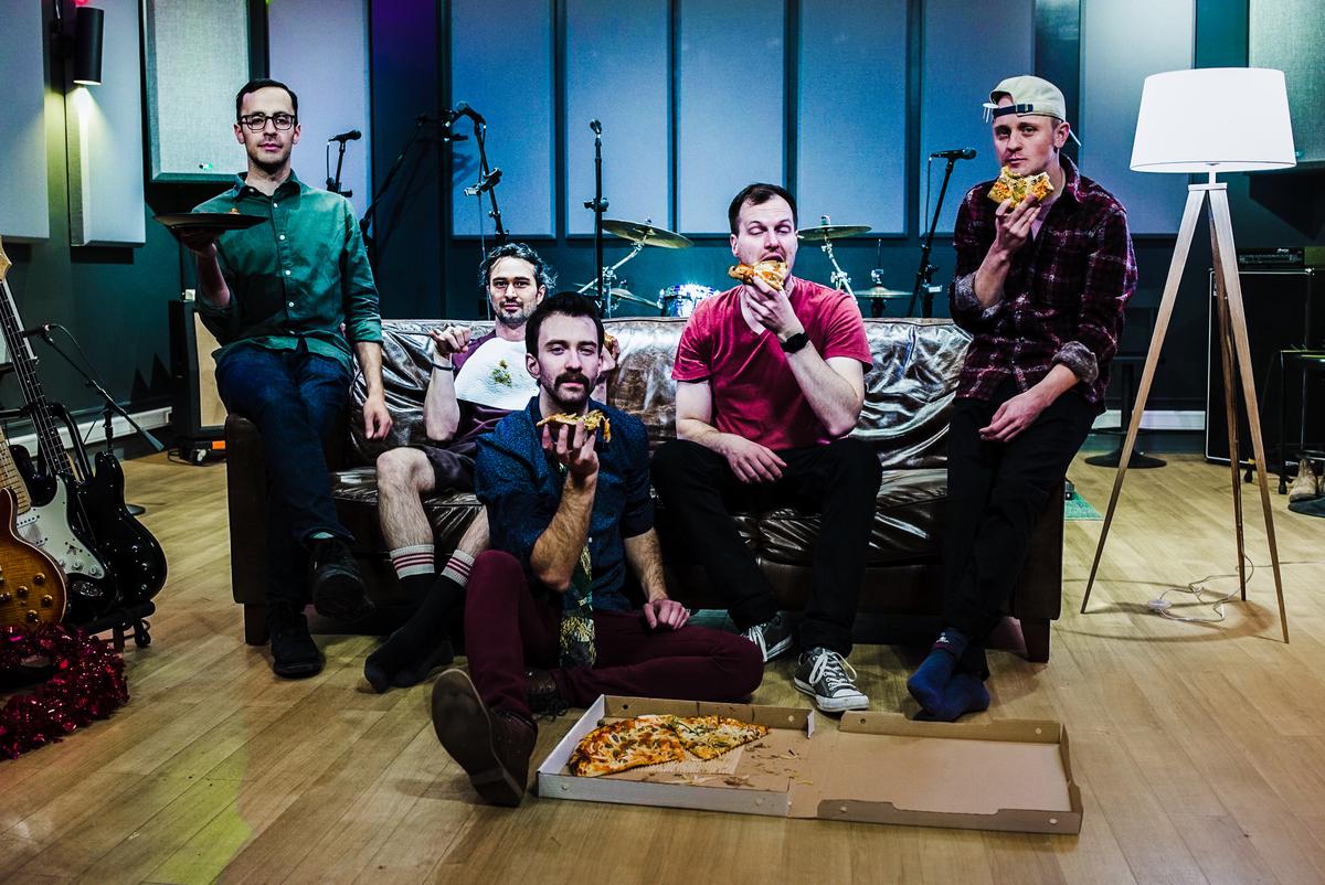 A fun photo of us all eating pizza on a couch